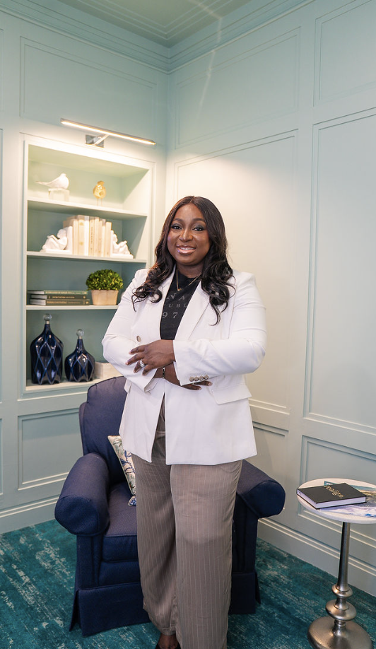 Lady Adeola smiling in a white blazer